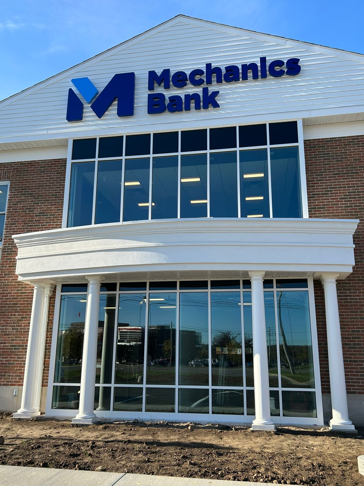 Mechanics Bank building with large windows and a blue logo against a brick facade.