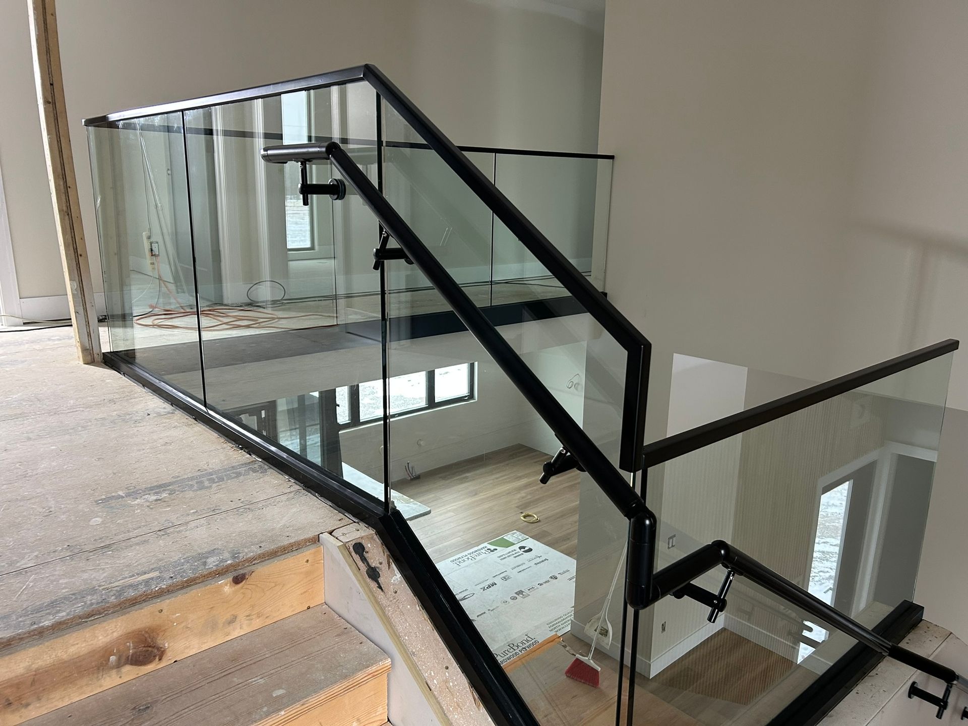 Black metal and glass railing system on a staircase.