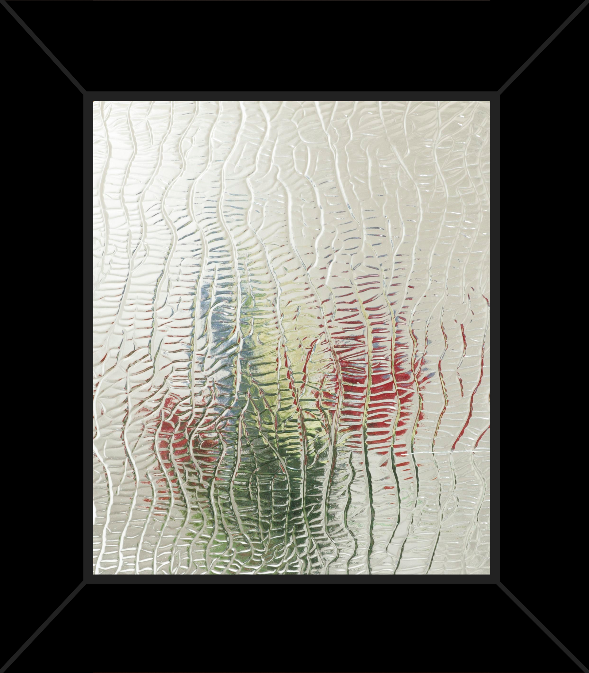 A picture of a vase of flowers behind a glass window in a black frame.