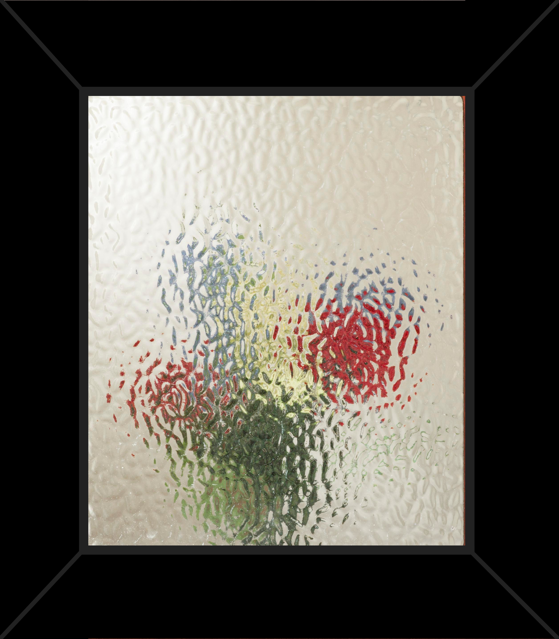 A picture of flowers in a glass vase in a black frame
