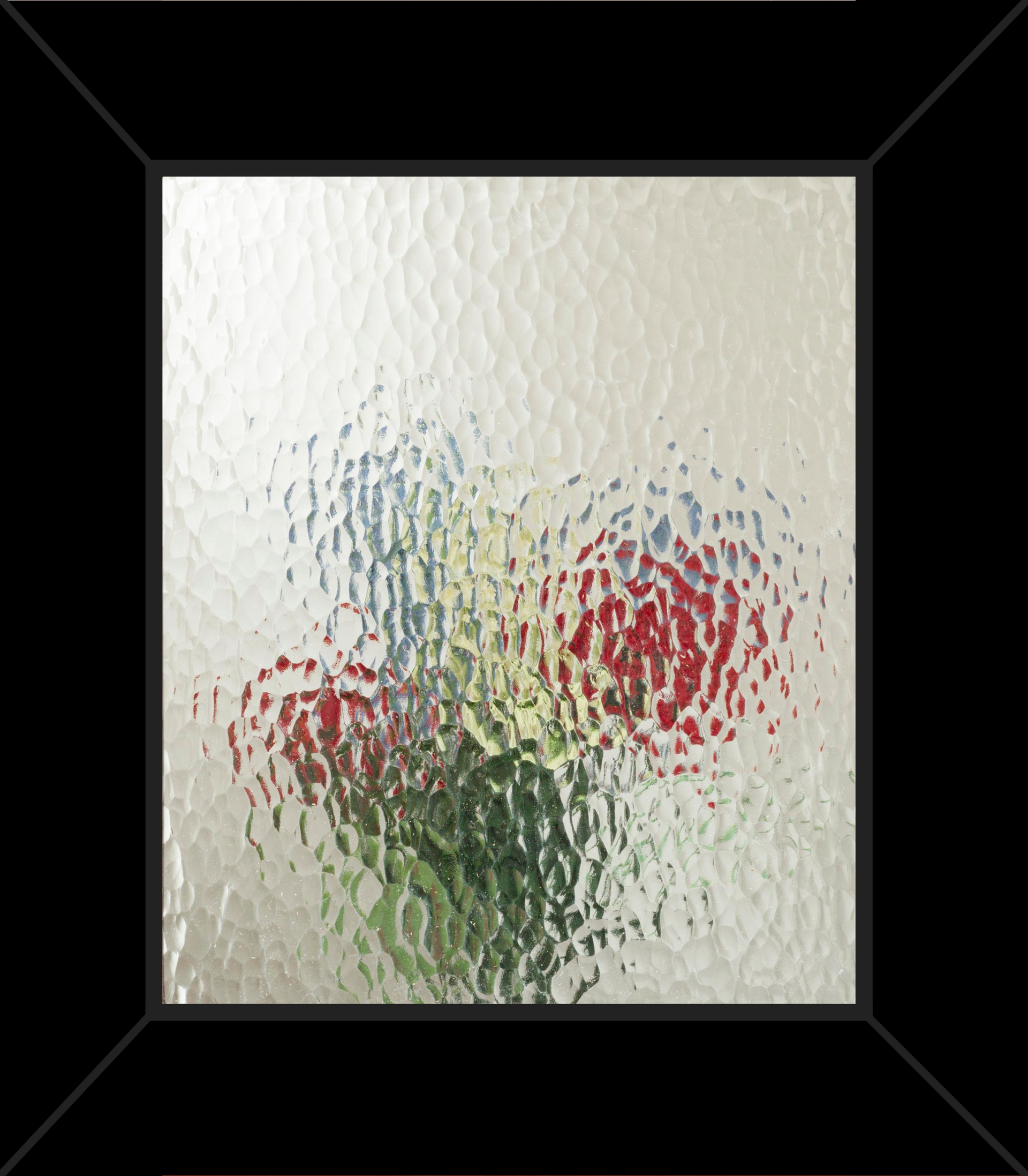 A picture of flowers in a glass vase in a black frame