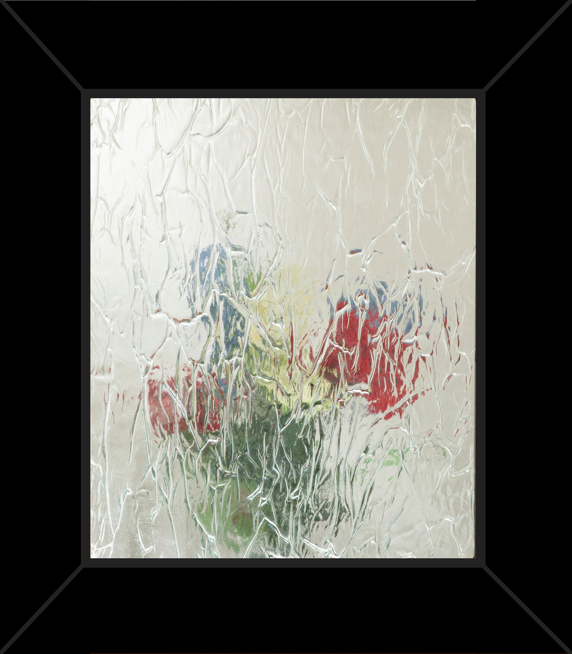 A picture of flowers in a vase behind a glass window.