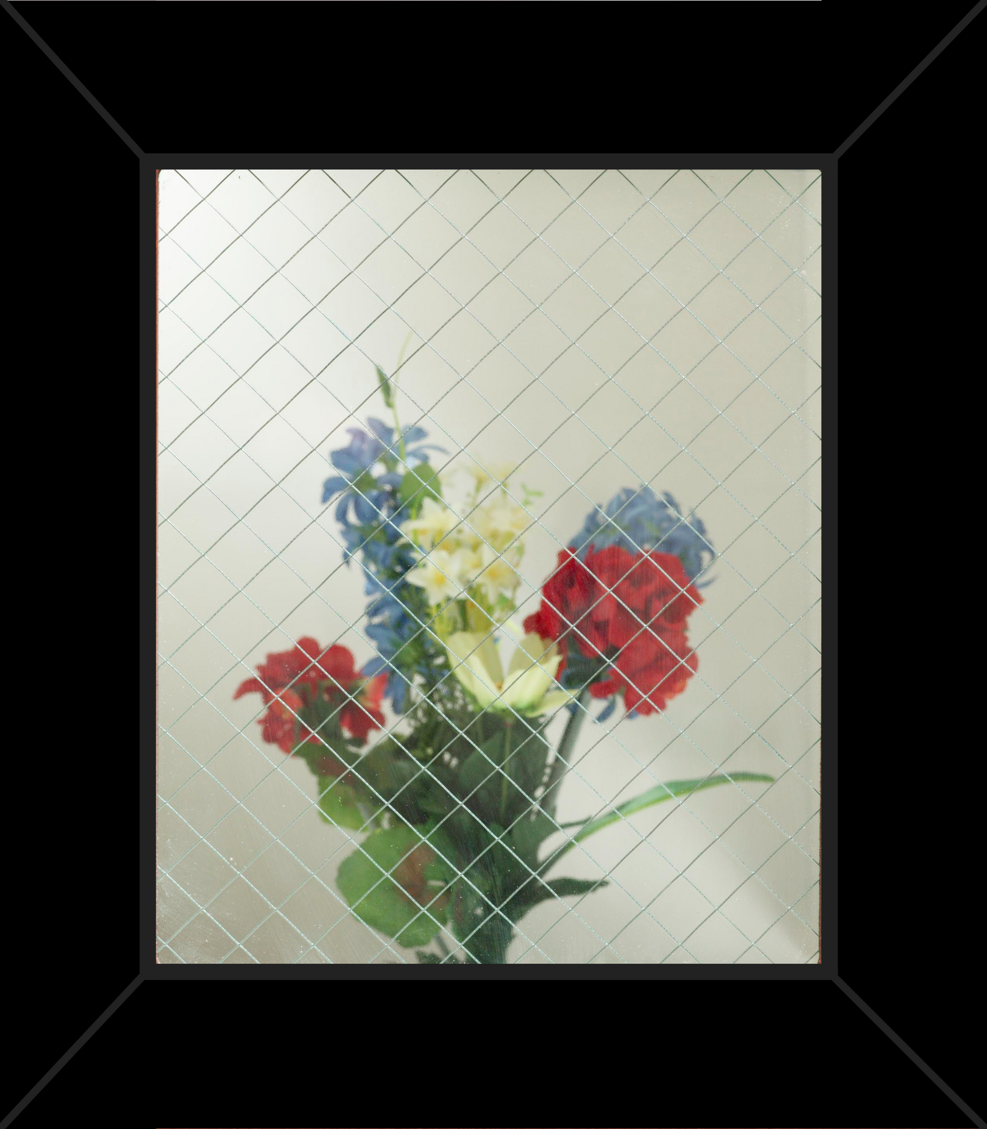 A picture of flowers in a glass vase in a black frame.