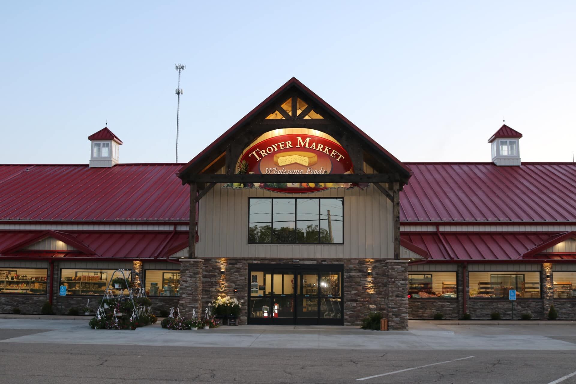 Teeth & Masonry store with a red roof, stone facade, and glass doors.