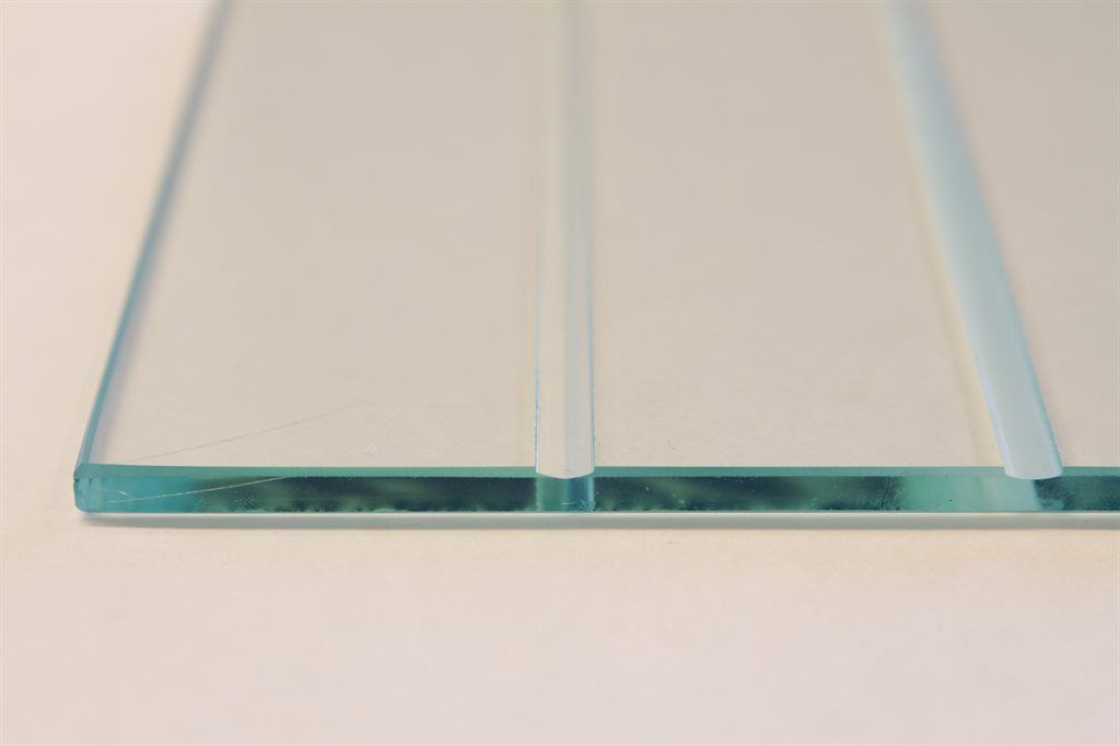 A close up of a piece of glass on a white surface.