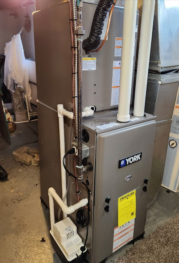 A York HVAC unit in a residential setting with white pipes and black wires in downriver michigan.