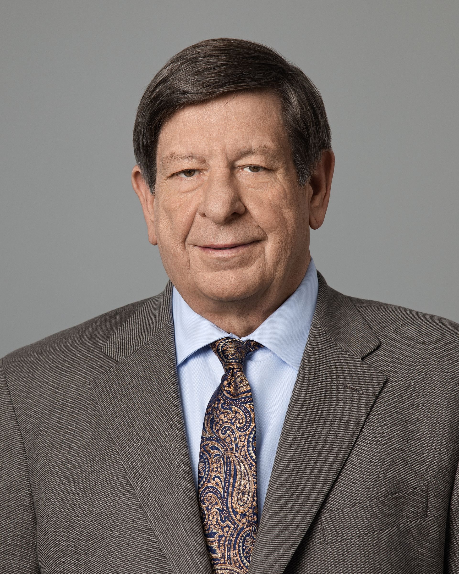 A man in a suit and tie is smiling for the camera.