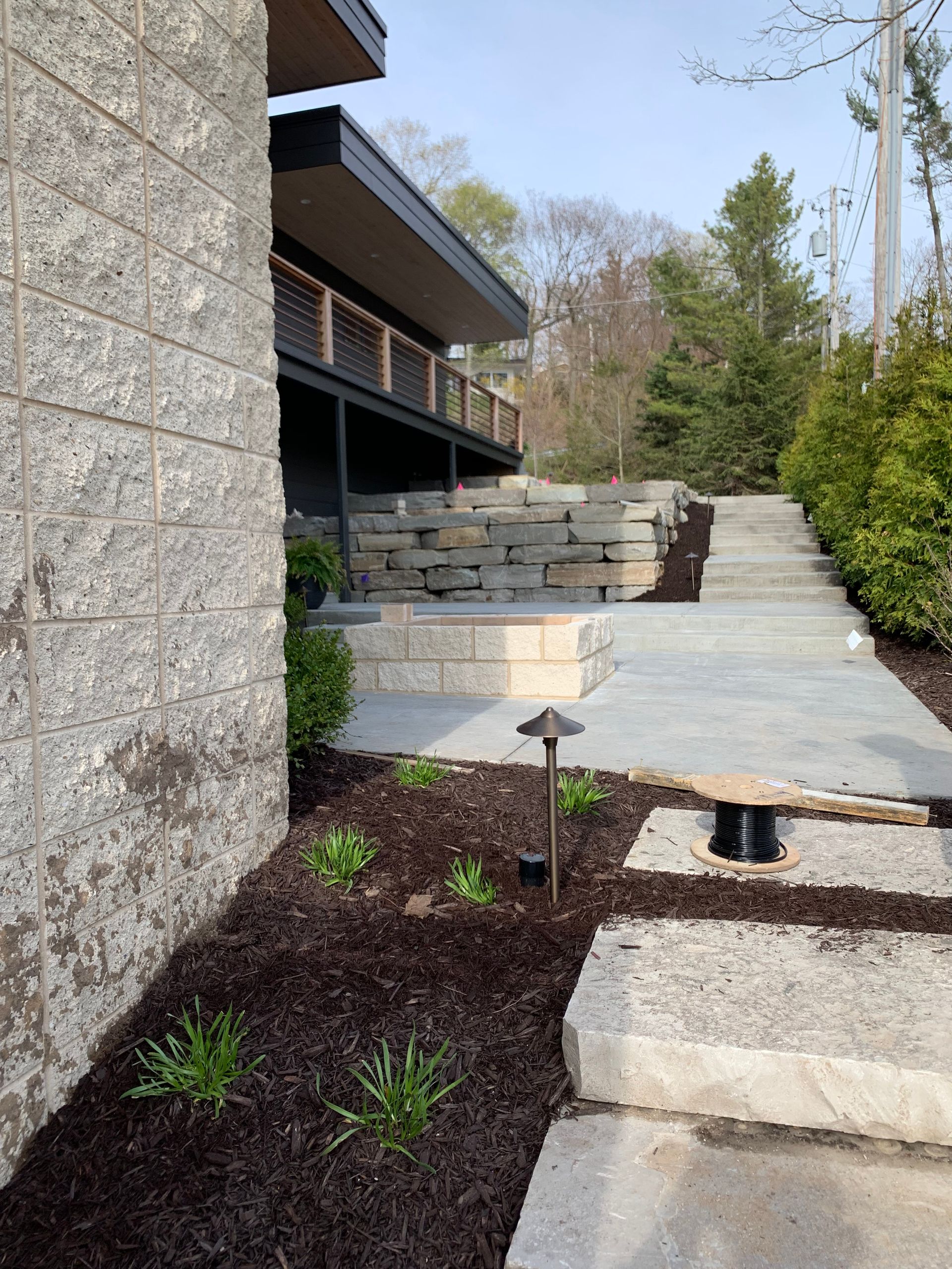 Exterior view of a modern building with stone walkway and landscaping.