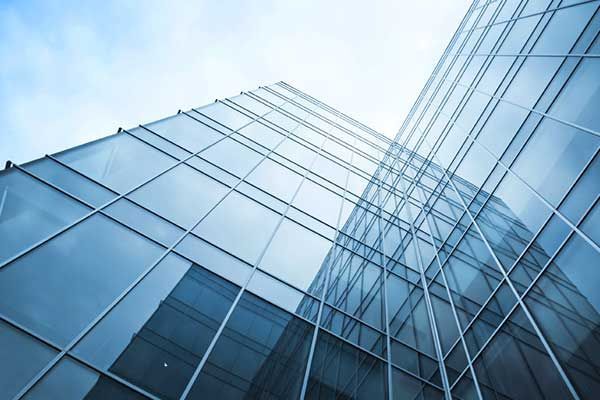 Modern building with reflective glass windows showcasing commercial glass.