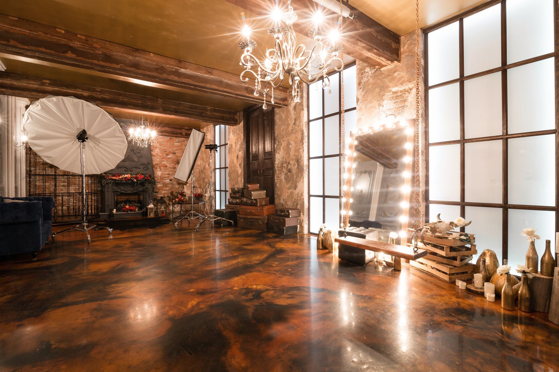 It is a large room with a lot of windows and a wooden floor.