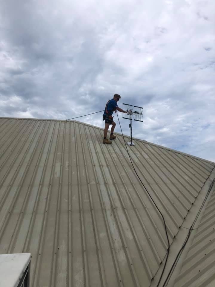 Rooftop View of a City Skyline on a Clear Day, With a TV Antenna in the Foreground — BRC Antenna Service 1 In Byron Bay, NSW