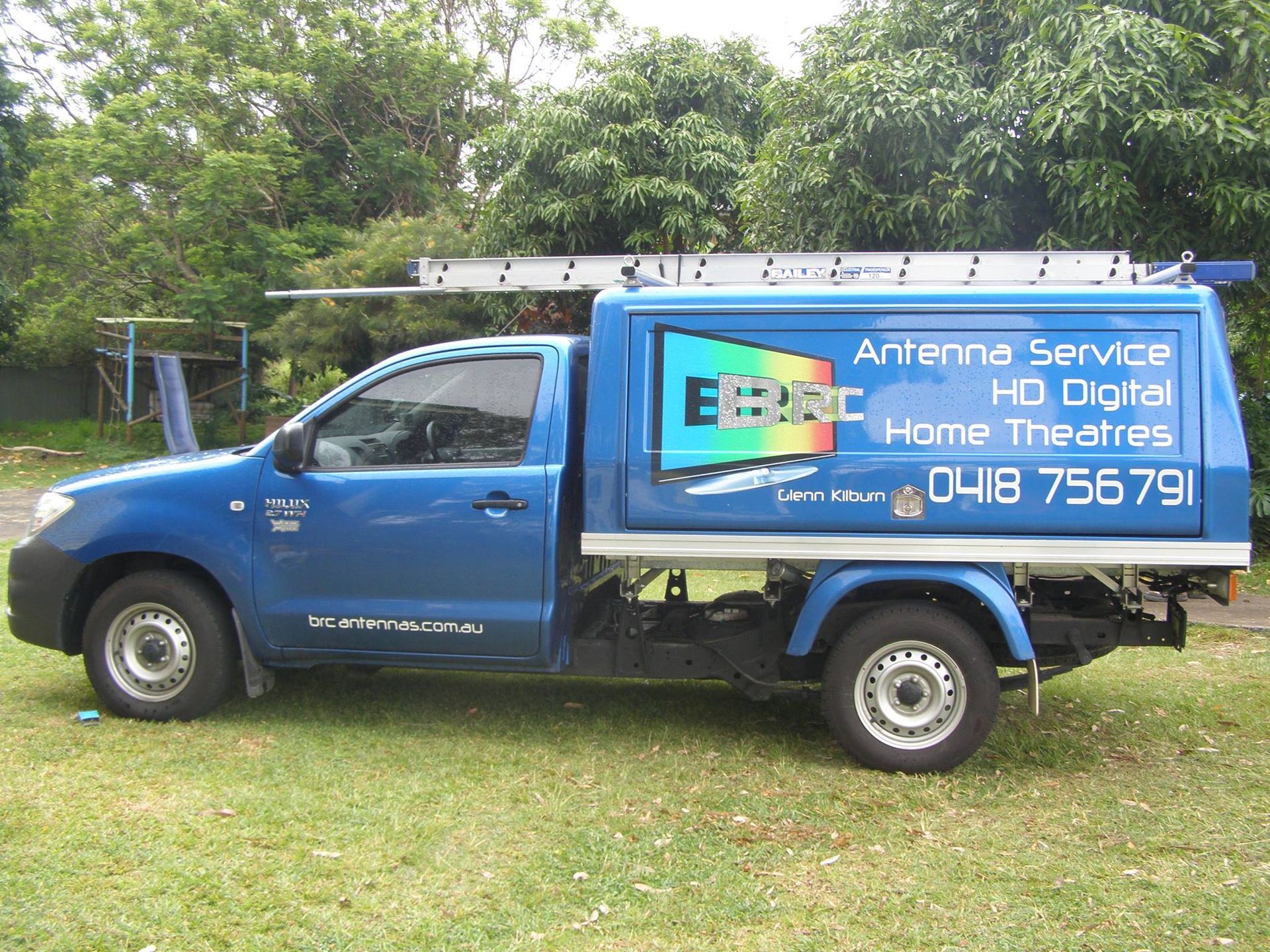 Blue Truck With Antenna Service Signage, Ladder on Top — BRC Antenna Service 1 In Banora Point, NSW