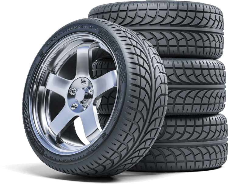 Shiny car wheel with tire beside a stack of tires.