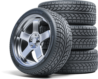 Shiny car wheel with tire beside a stack of tires.