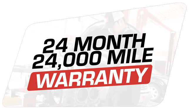 24-month/24,000-mile warranty badge in red and black on a white and blurred background of a vehicle.