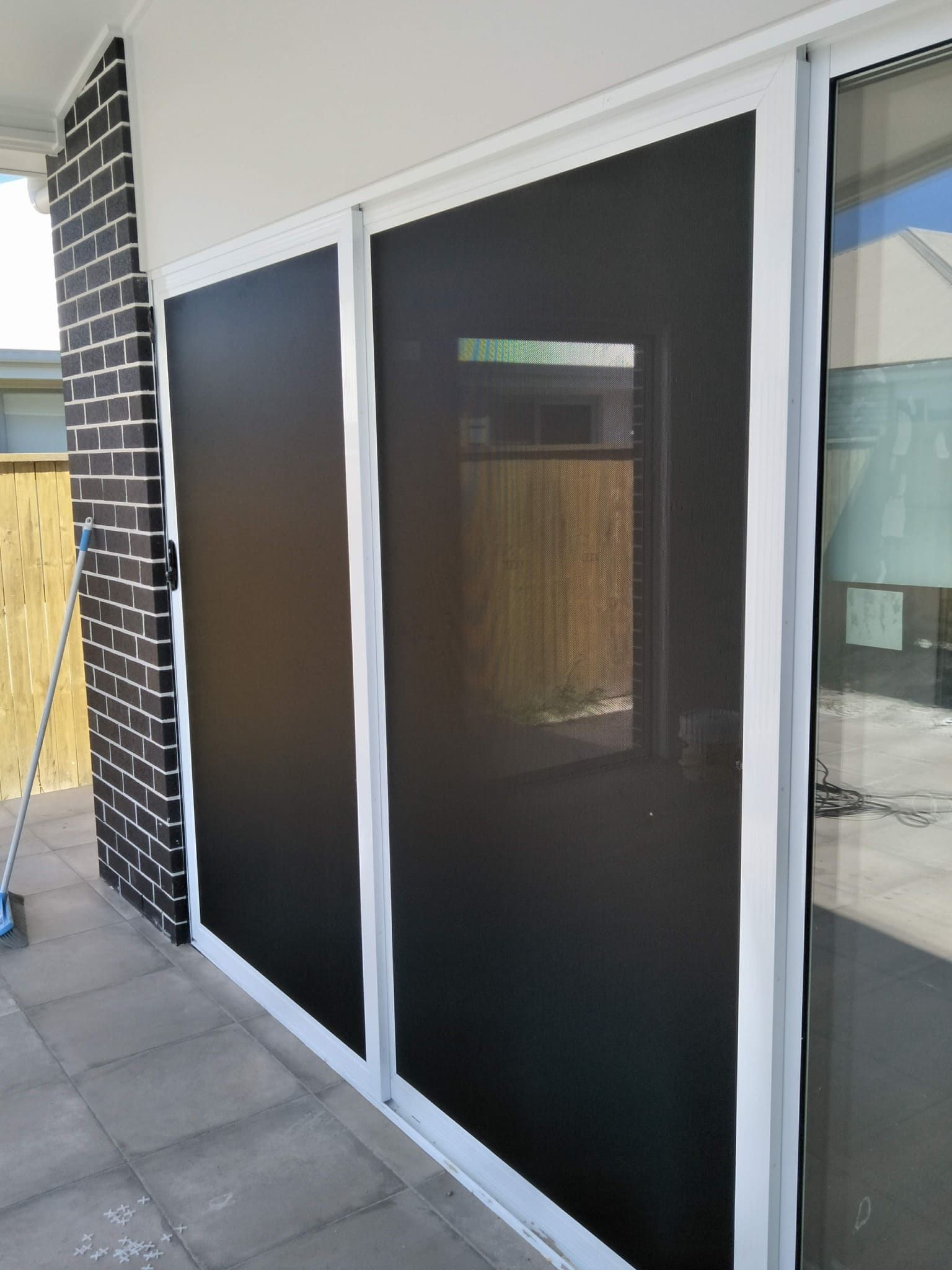A Sliding Glass Door with A Screen on It — Hervey Bay Glass Glazing & Screens In Pialba, QLD