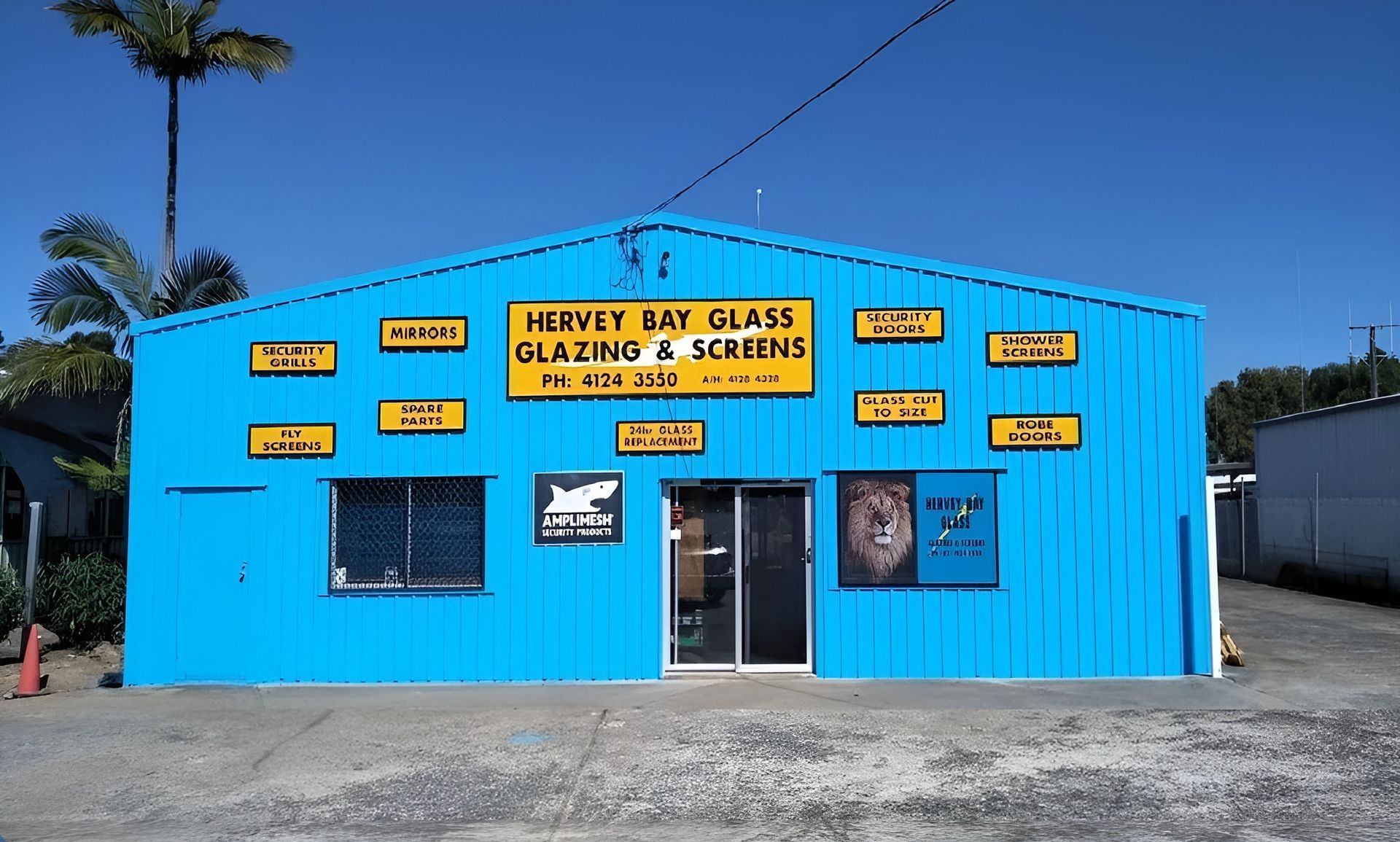 A Blue Building with A Yellow Sign that Says 