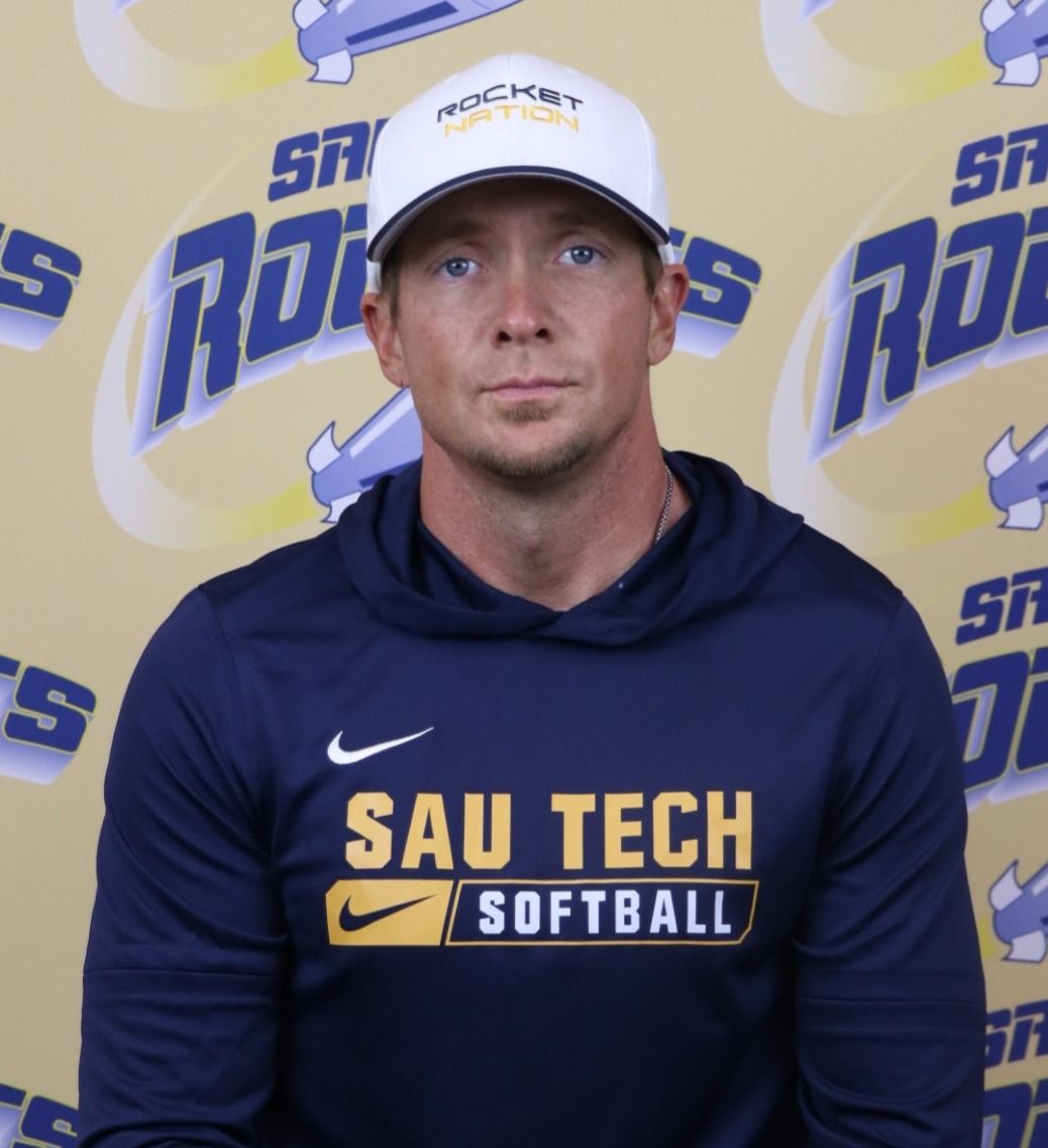 Man wearing a white hat, navy sweatshirt with 