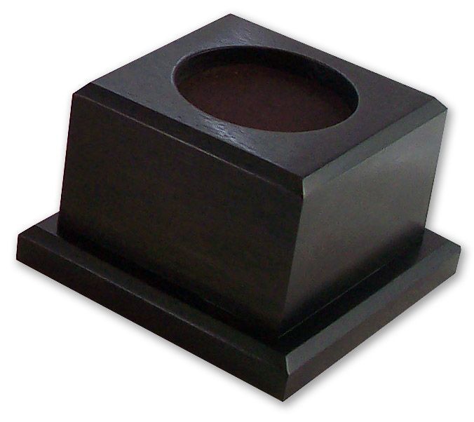 A small wooden box with a hole in the middle