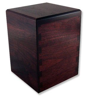 A wooden cube with a black border on a white background