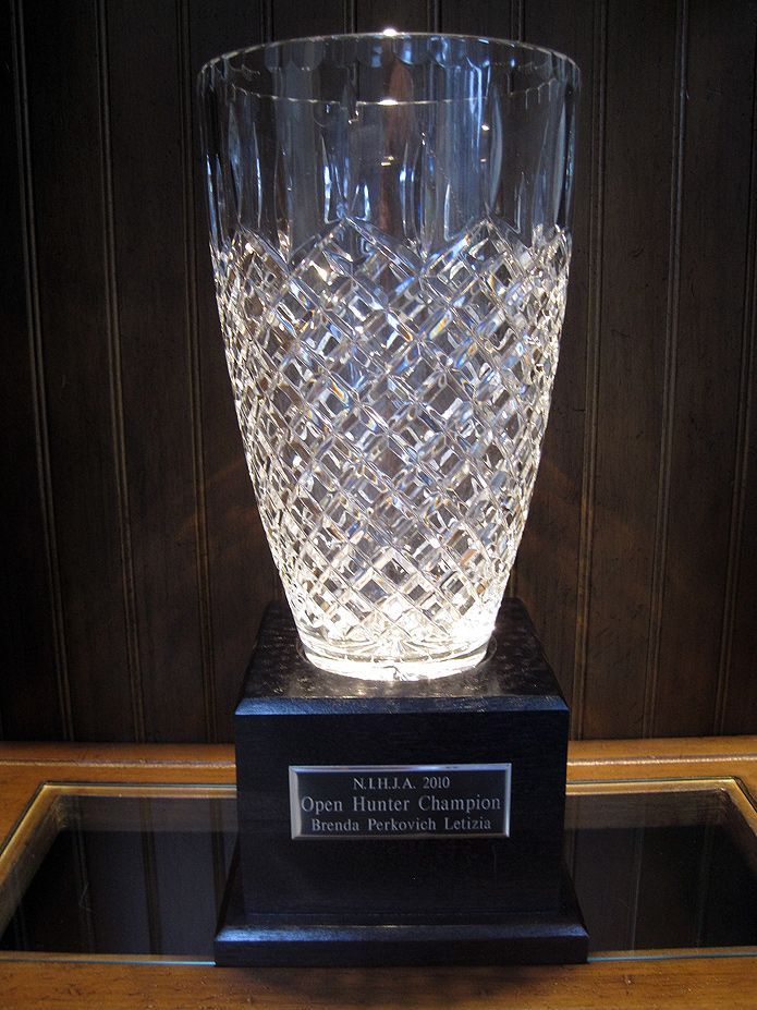 A clear glass vase sitting on top of a glass table