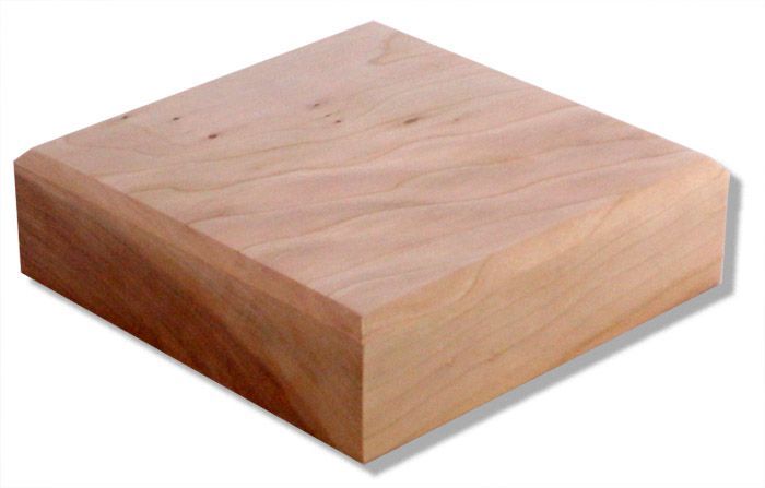 A square piece of wood with a shadow on a white background