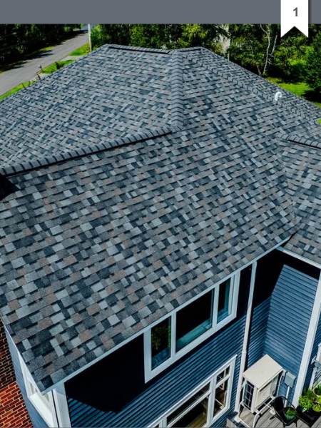 An aerial view of a blue house with a gray roof