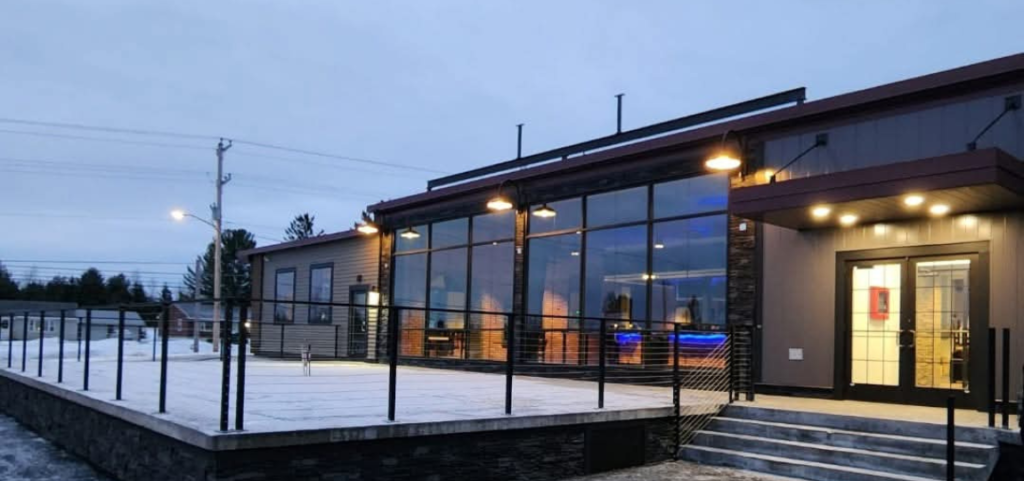 A large building with a lot of windows is lit up at night.