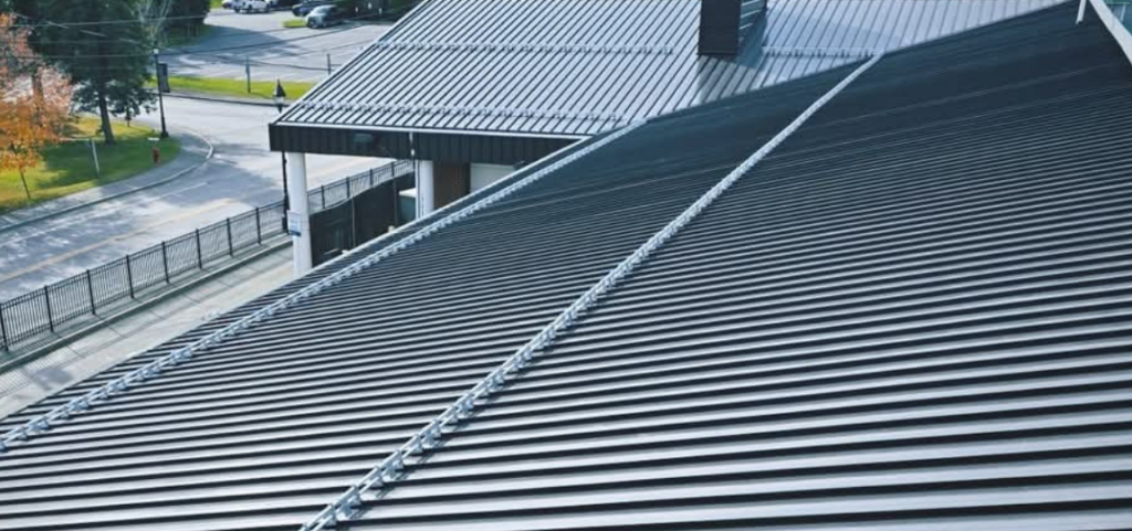 A close up of a roof with a fence in the background
