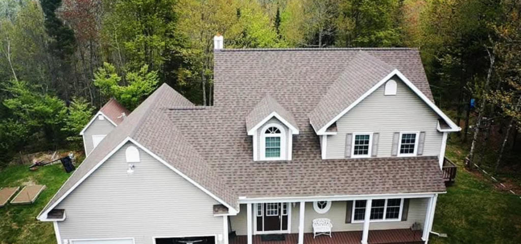 An aerial view of a large house surrounded by trees.