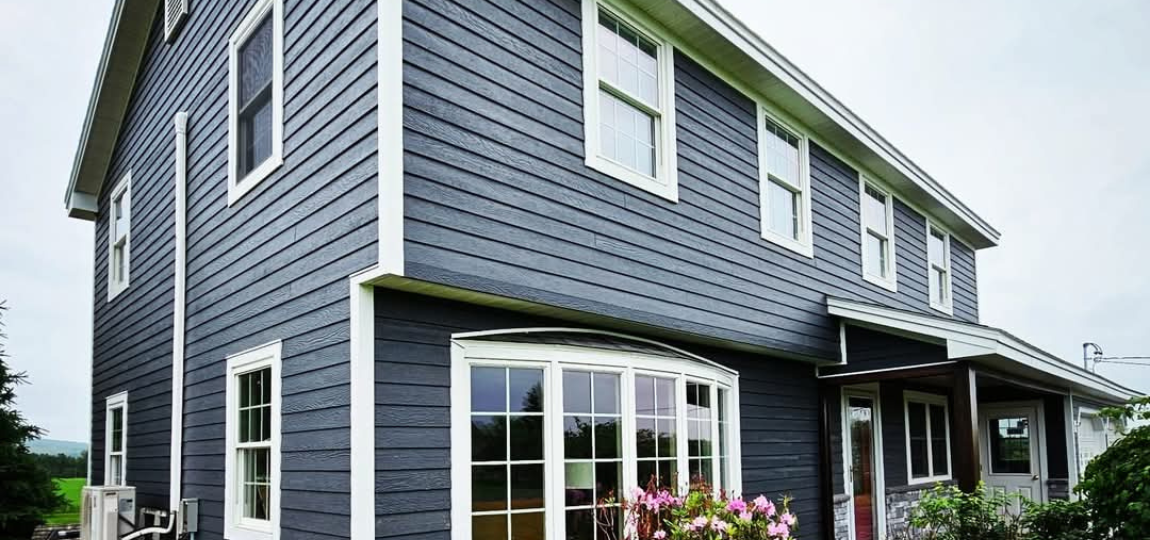 A large house with a lot of windows and flowers in front of it.