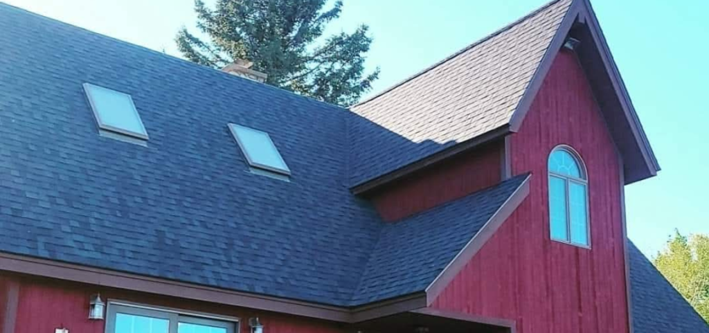 A red house with a blue skylight on the roof