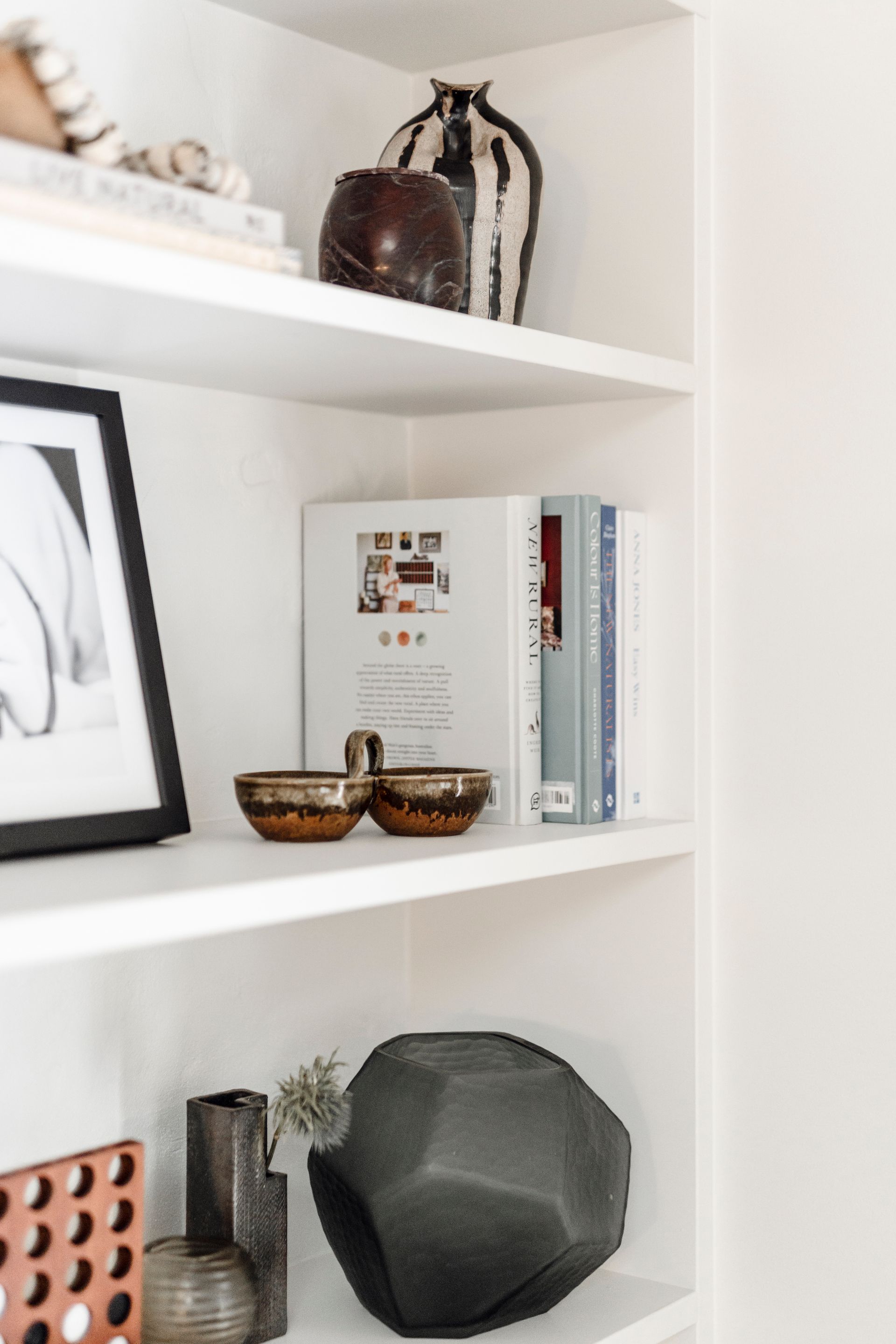 White shelves with decorative items: art, books, vases, and bowls — Stark Building & Constructions In Gerringong, NSW