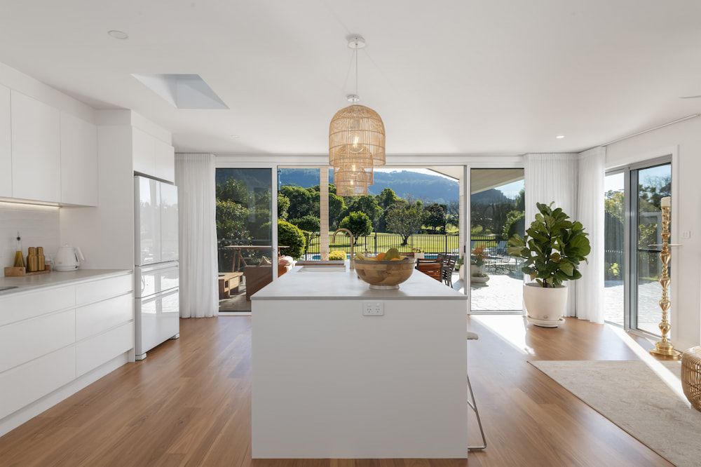 Bright Kitchen With White Cabinets, Island — Stark Building & Constructions In Berry, NSW 
