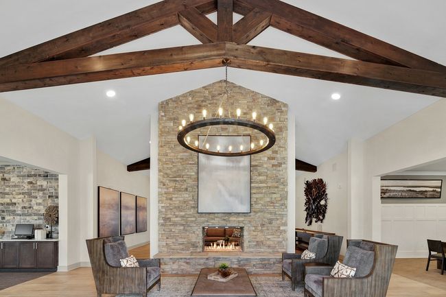 There is a fireplace in the middle of the community room.
