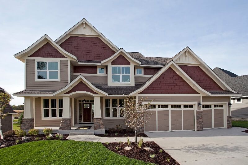 A large house with a lot of windows and a red roof