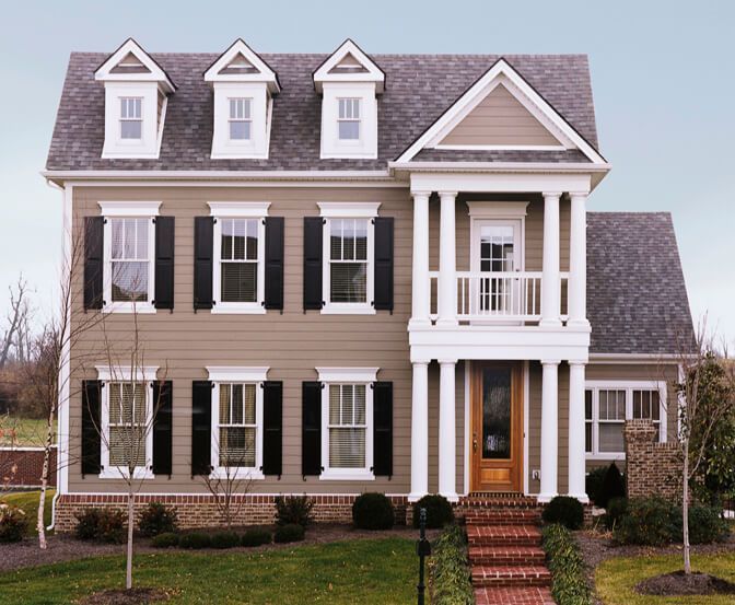 A large house with black shutters on the windows