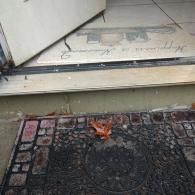 A light-colored welcome mat reading 