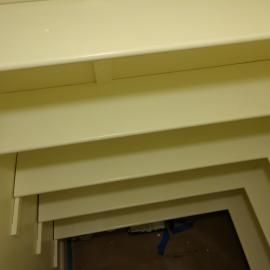 Stacked, cream-colored shelf units seen from a top-down, angled perspective.