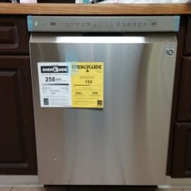 A stainless steel LG dishwasher installed under a wooden countertop with a yellow EnergyGuide label on the front panel.