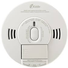 A close up of a smoke detector on a white background.
