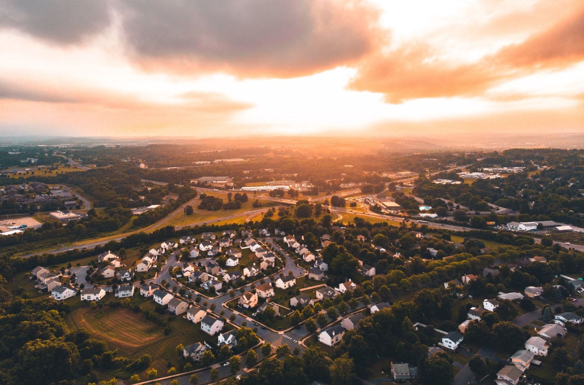 an aerial view of a residential area at sunset .