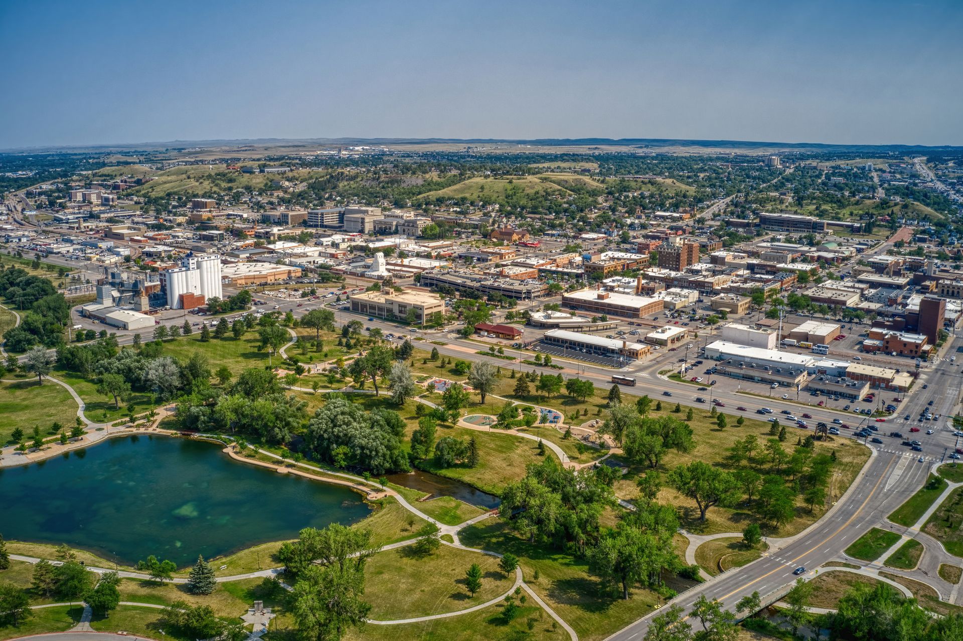 an aerial view of a city with a lake in the middle of it .