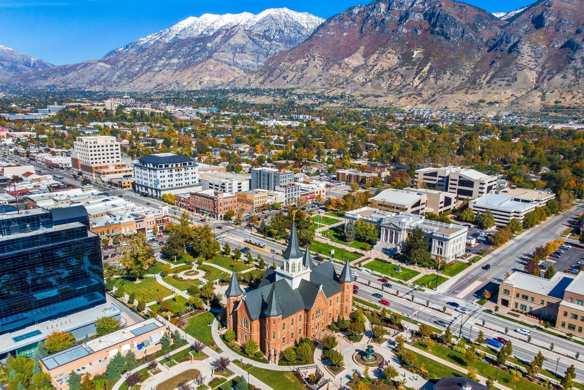 an aerial view of a city with mountains in the background .