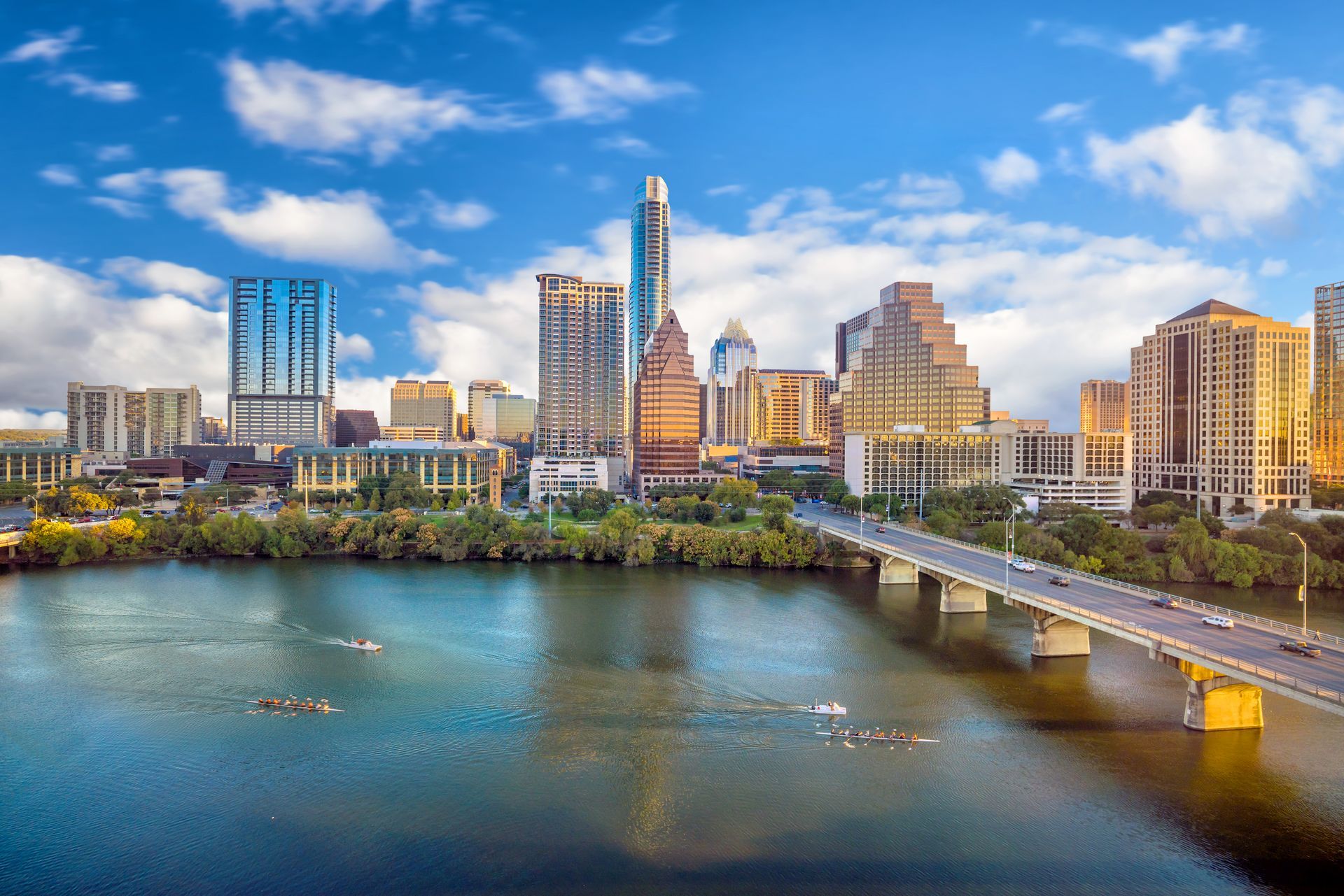 an aerial view of a city skyline with a bridge over a body of water .