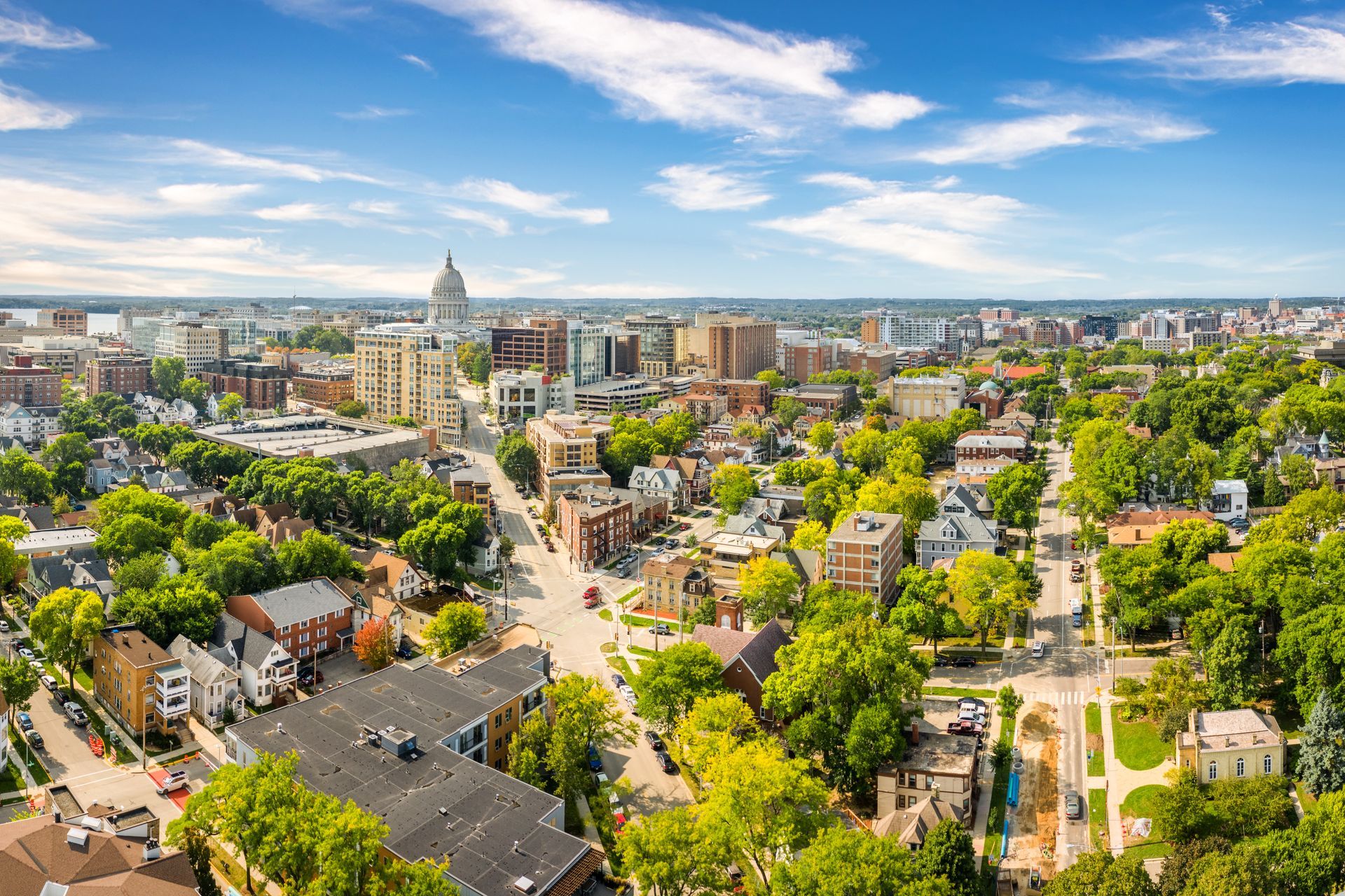 an aerial view of a city surrounded by trees and buildings .