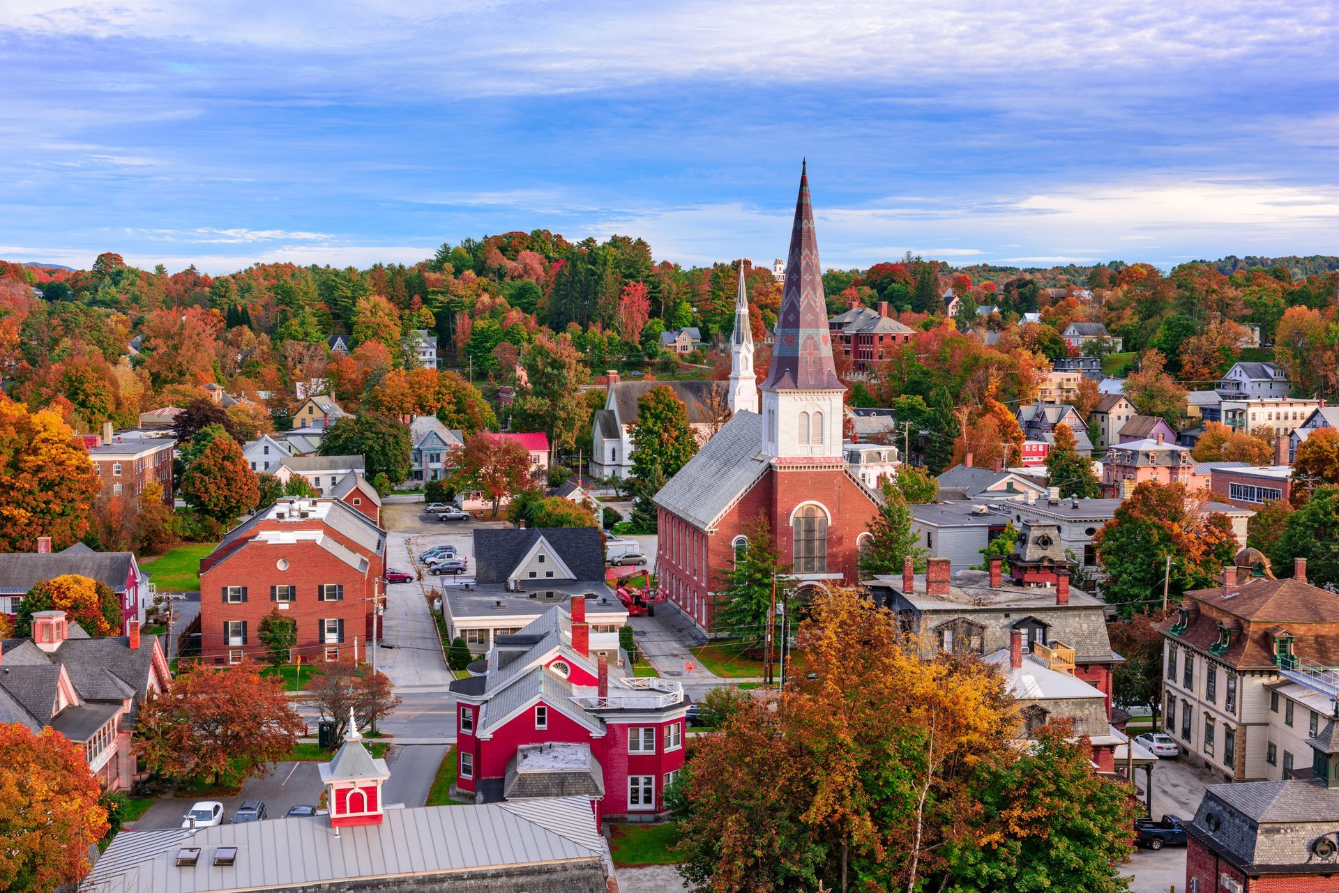 an aerial view of a small town with a church in the middle of it .