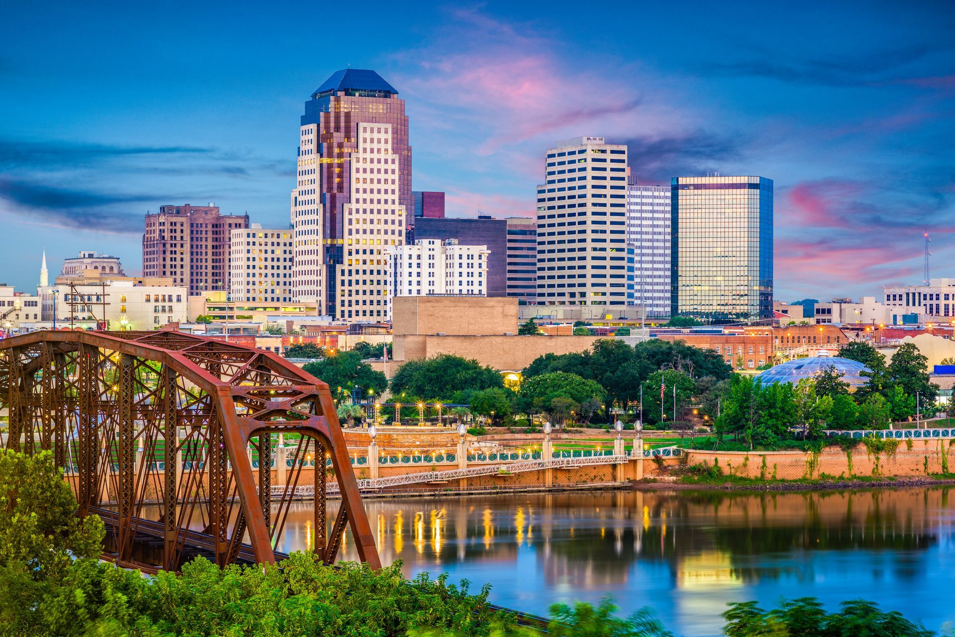 there is a bridge in the foreground and a city skyline in the background .