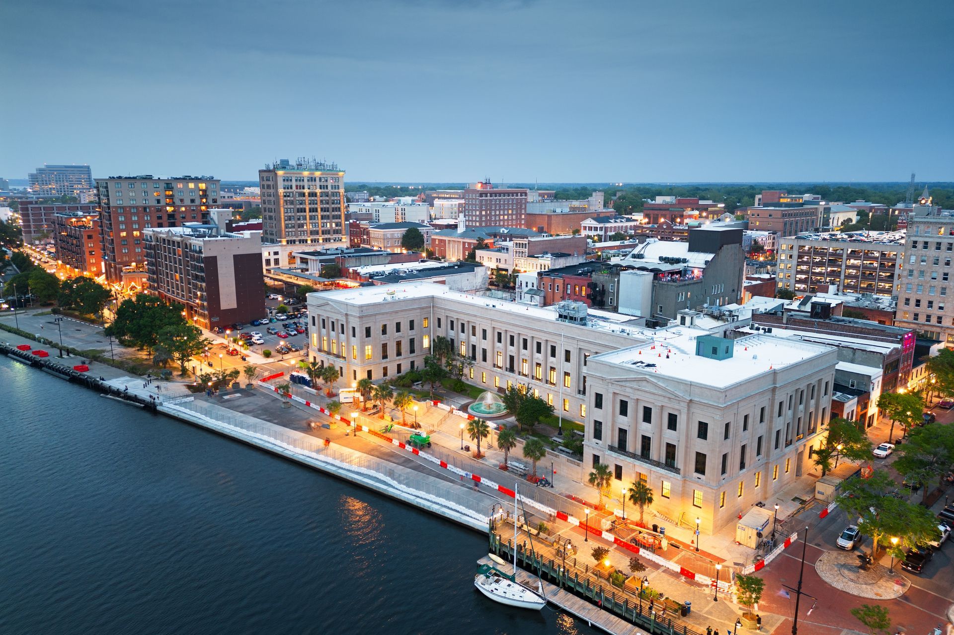 an aerial view of a city at night with a large building in the middle