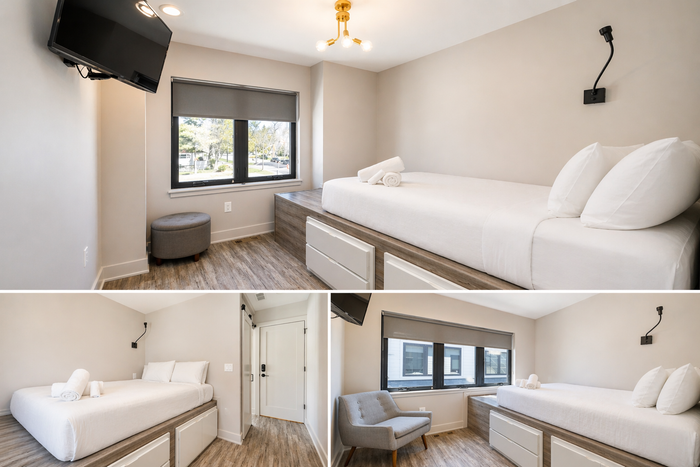 Bright bedroom with white bedding, large windows, gray accents, and wood floors